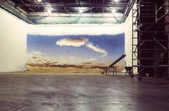 Large warehouse wall size painted sky canvas in studio